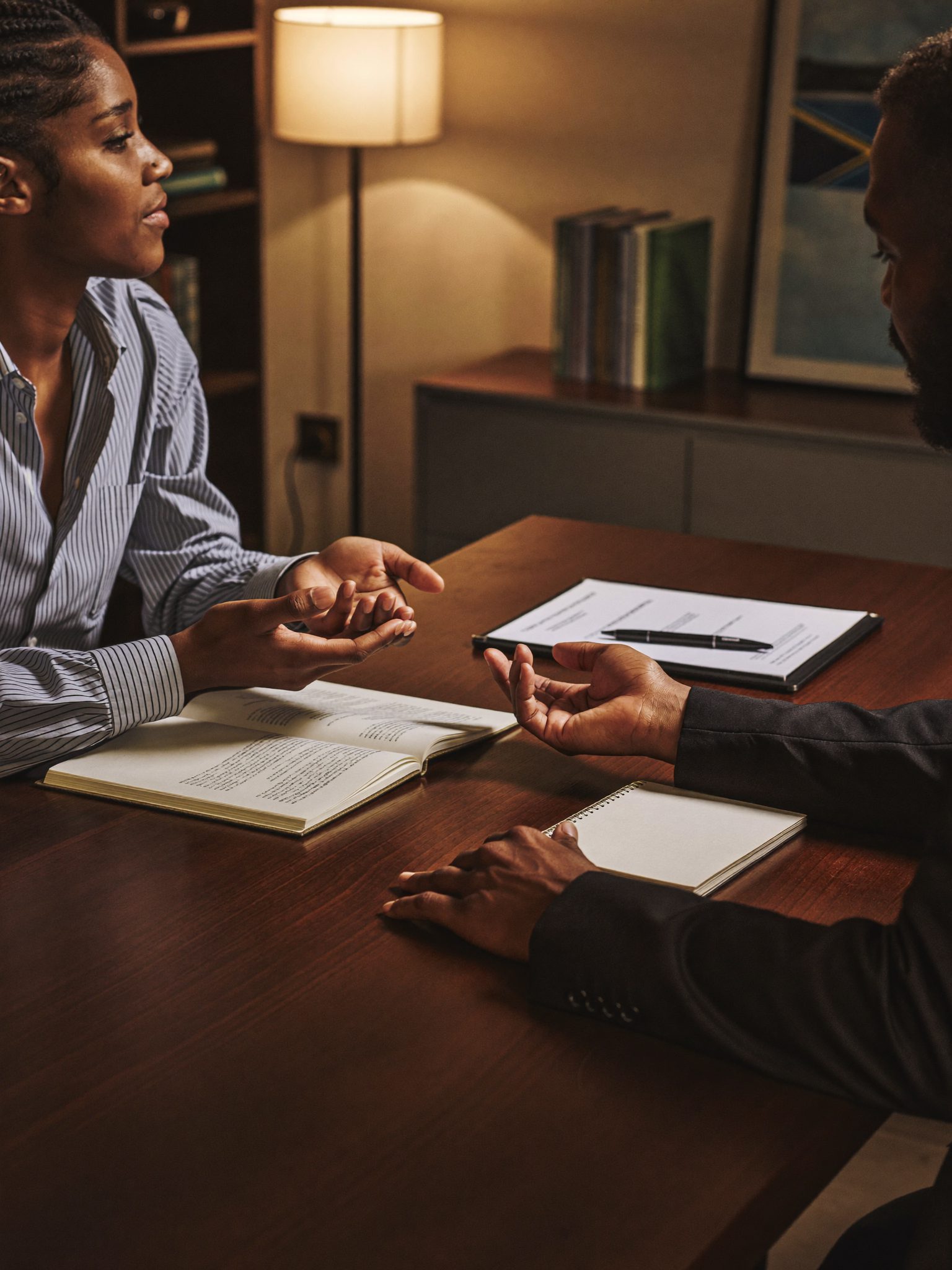 A financial advisor mid-conversation over the desk at the Du Toitspan Road office